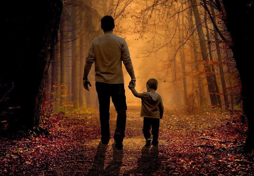 Picture of a dad holding his son's hand.